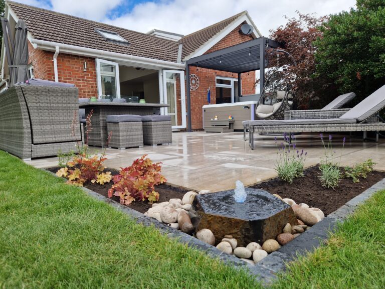 back garden with a patio, gazebo, hot tub and water feature
