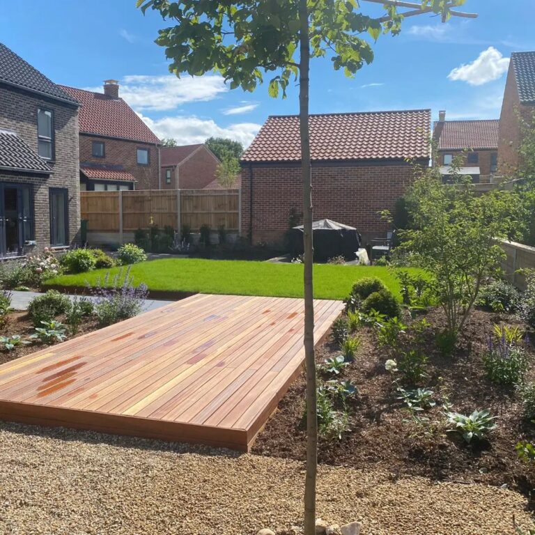 square formal lawn with wooden decking bridge