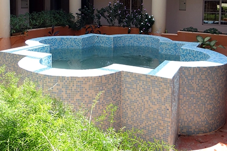 Raised mosaic and brick fish pond